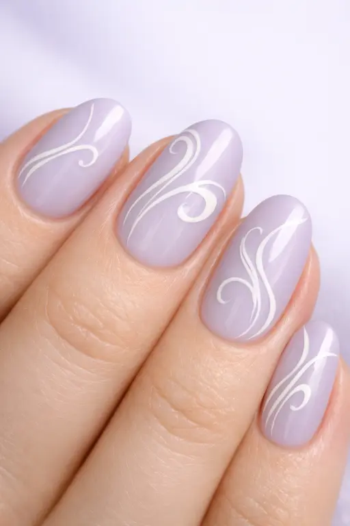 Close up macro photograph of a woman's hand with pale lavender nails featuring flowing white swirl designs